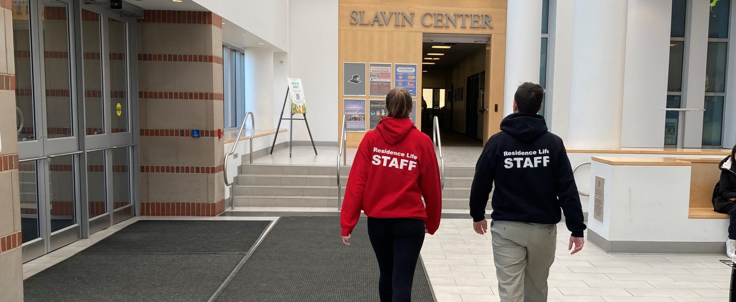 Two staff members walking in Slavin Center.