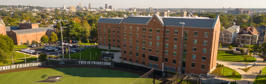 Aerial photo of softball field and Shanley Hall with Providence skyline in the background