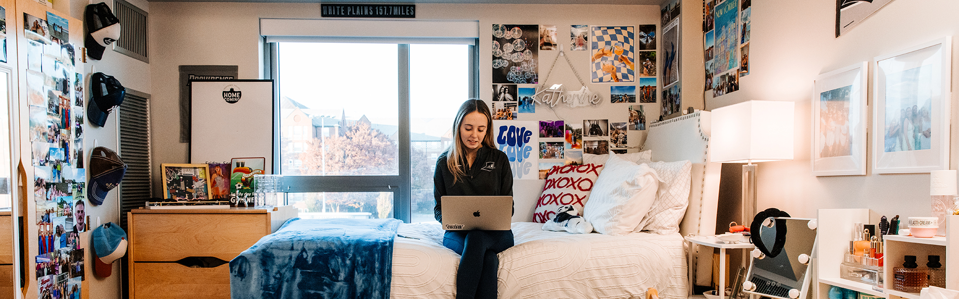 Student sitting on her bed in Shanley Hall